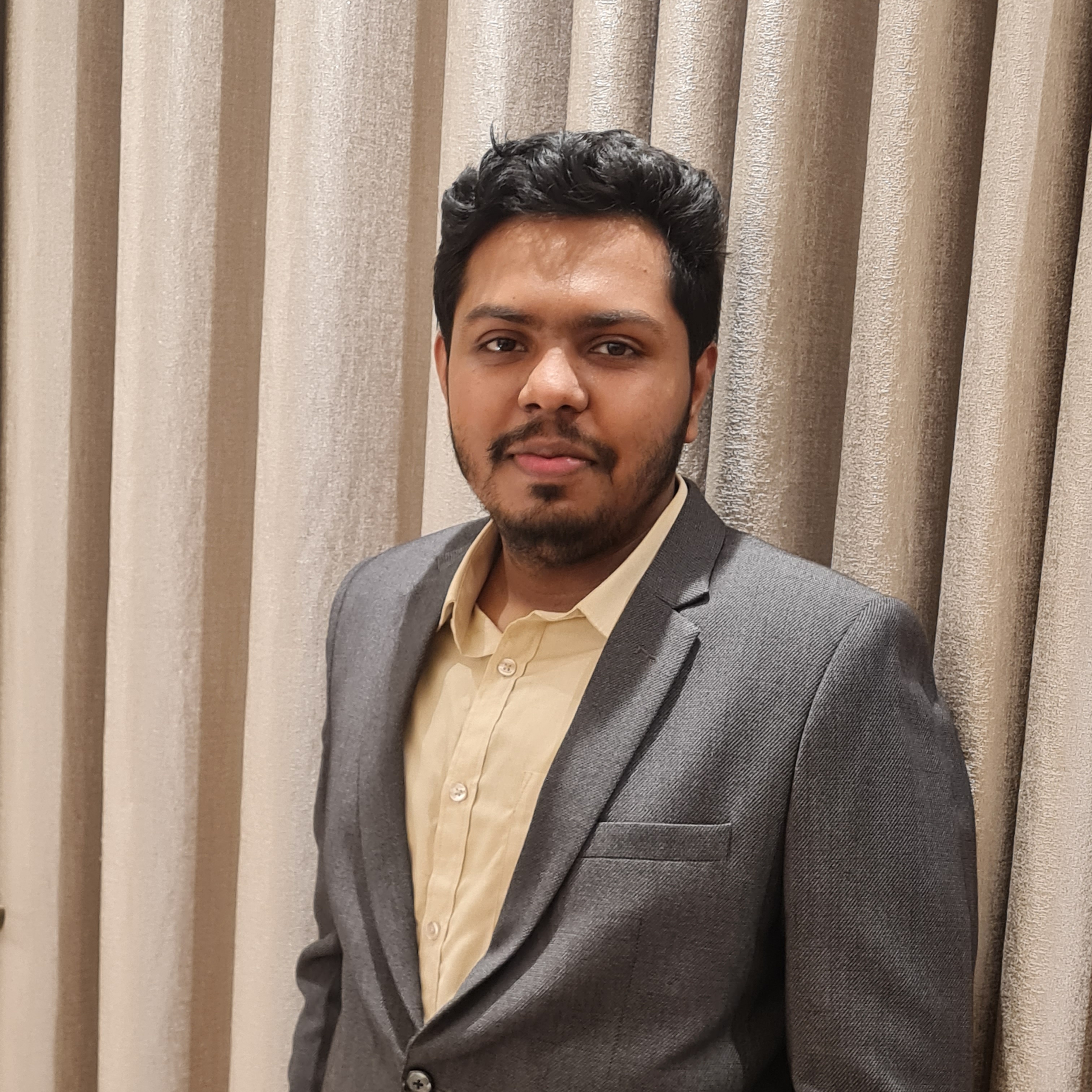A professional headshot of a confident Bangladeshi entrepreneur in business casual attire. He is smiling warmly against a soft-focus office background, radiating leadership and vision. The lighting is professional and clean, capturing a sense of reliable and approachable authority. - Punoshristi Bangladesh Plastic Recycling
